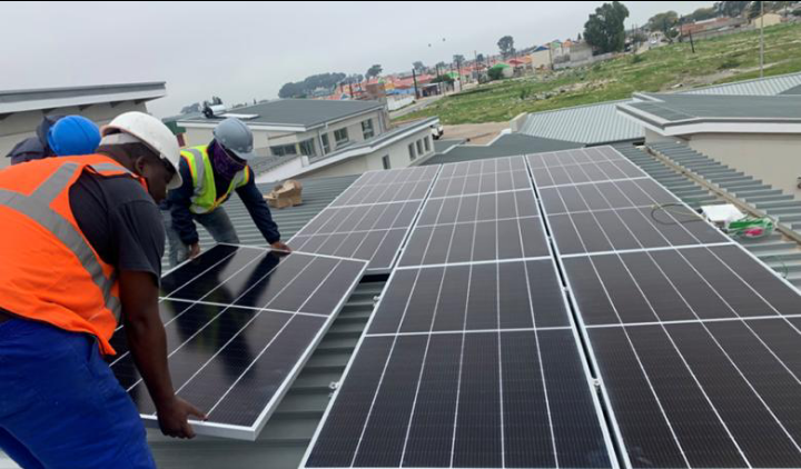 Hybrid solar systems installation in a rural Kenyan setting.